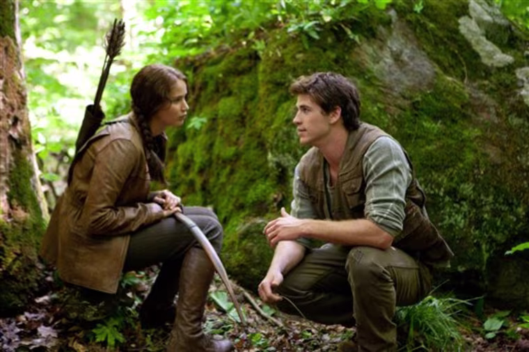 Jennifer Lawrence as Katniss Everdeen, left, and Liam Hemsworth as Gale Hawthorne in a scene from